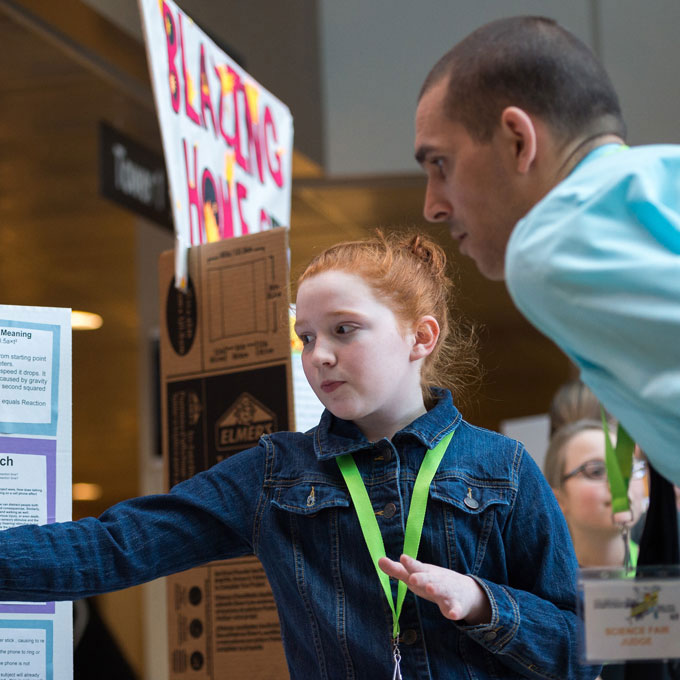A student explains a project to teacher at the Expo of Awesome event at UBC Okanagan